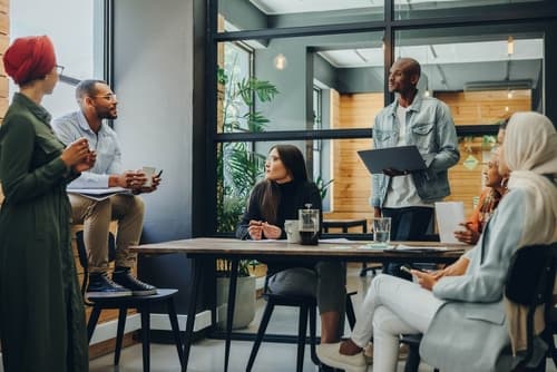 Two business professionals smiling stand confidently, symbolizing a connection to the future.