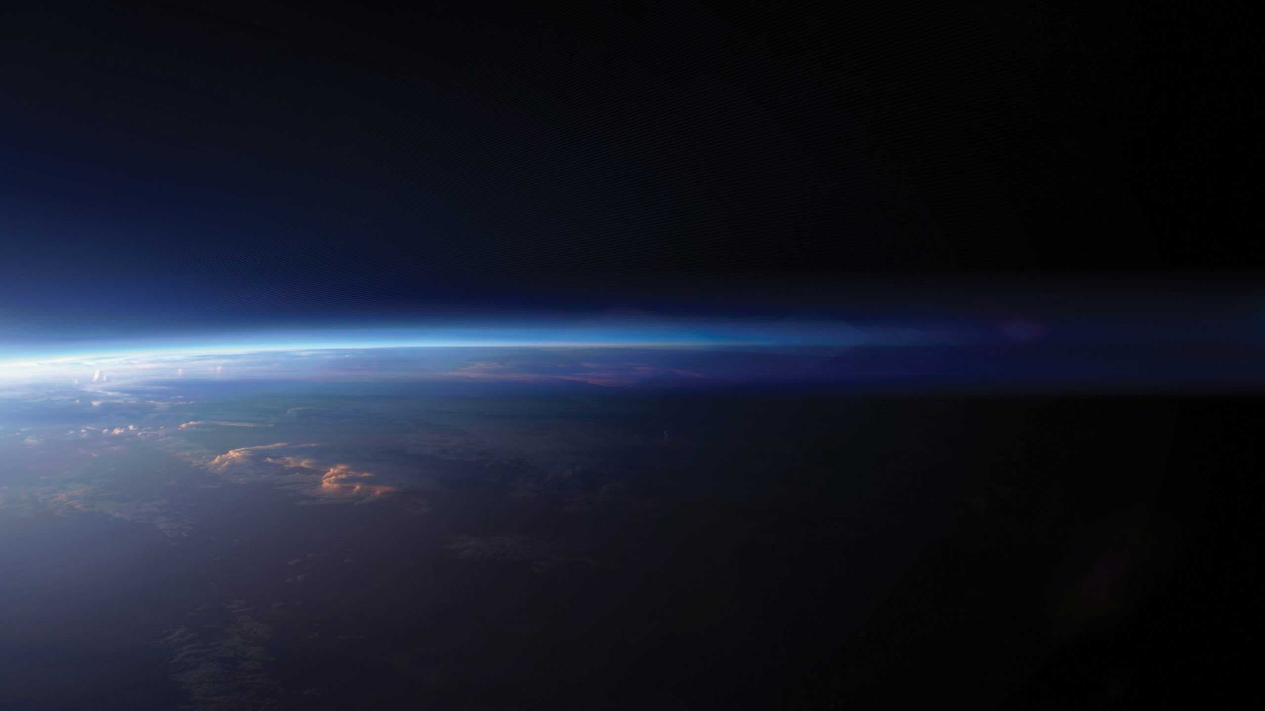 A view of Earth from space illuminated by a bright sun.
