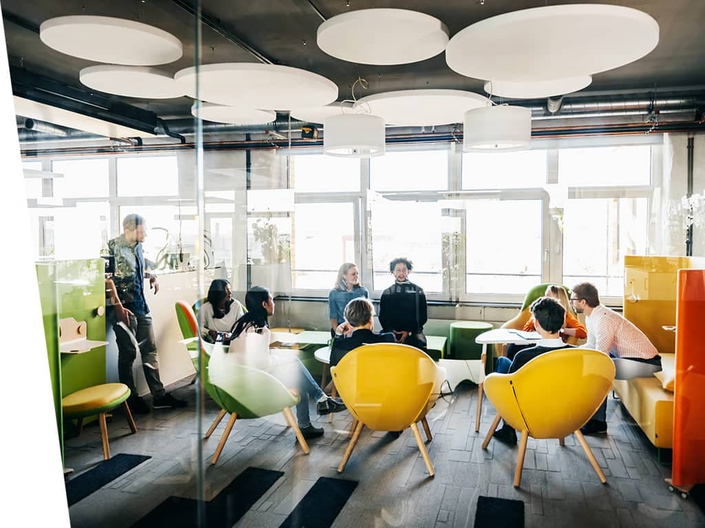 Modern work enviroment with group of people talking.
