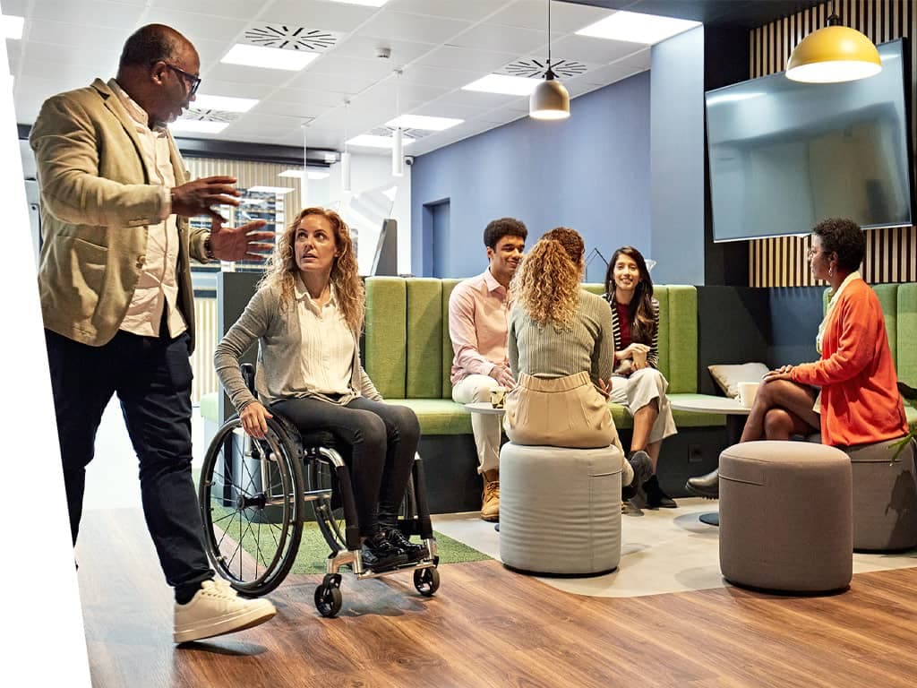 Modern work enviroment with group of people talking.