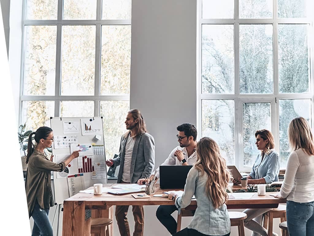 Casual work emviroment with people standing and talking.